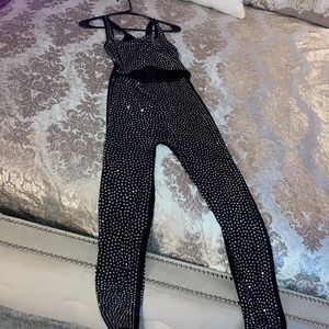 Black, one piece, pantsuit with a metallic silver design